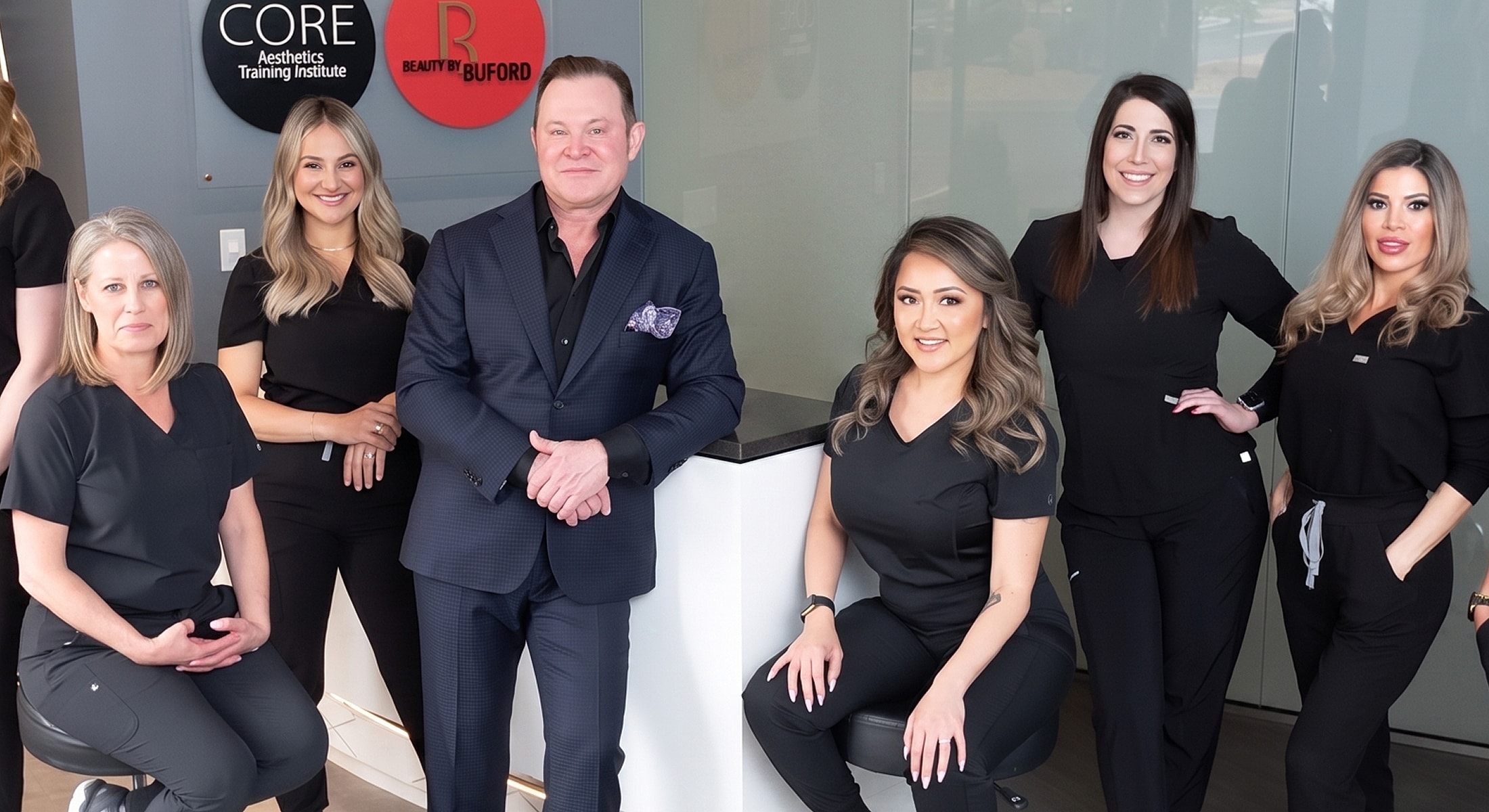 Aesthetic training team posing together at clinic.