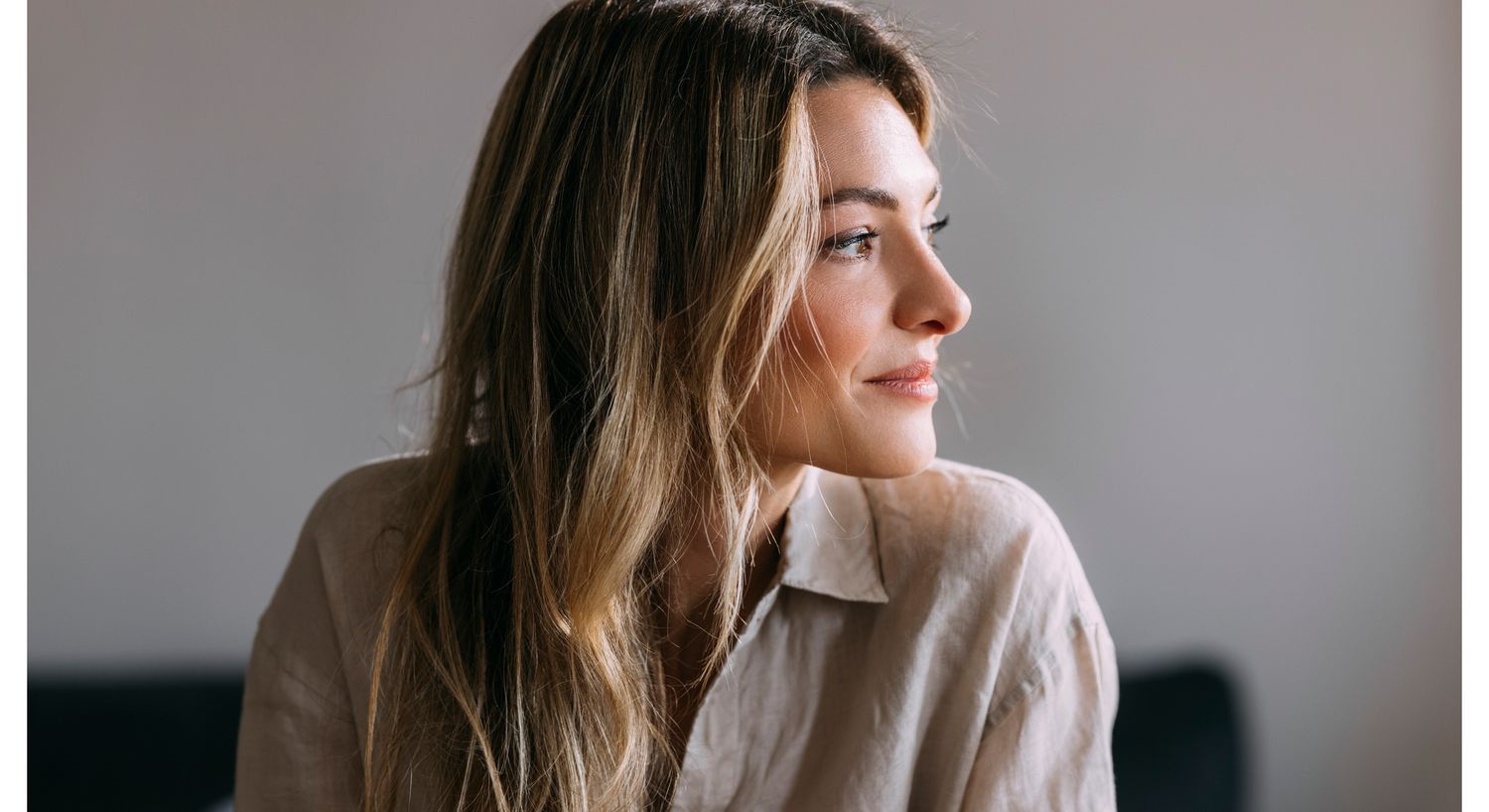 Profile of a woman with long, wavy hair.