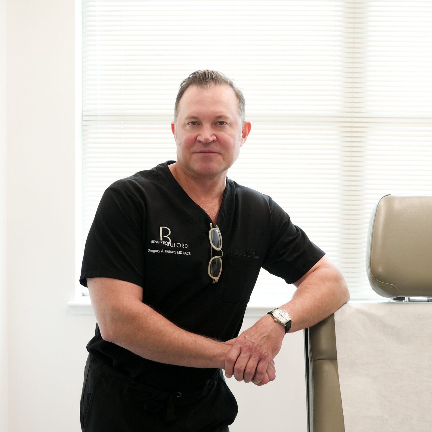 Doctor in black scrubs in a clinic setting.