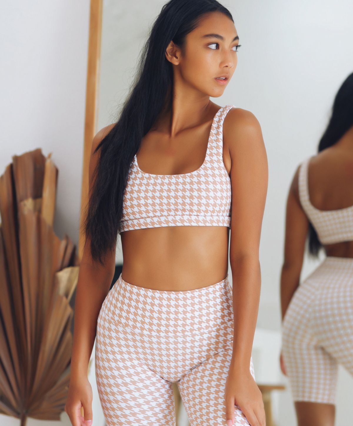 Model in stylish workout attire, showcasing confidence.