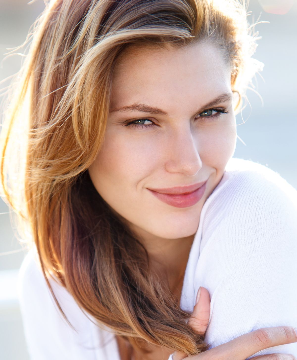 Smiling woman with long, flowing hair.