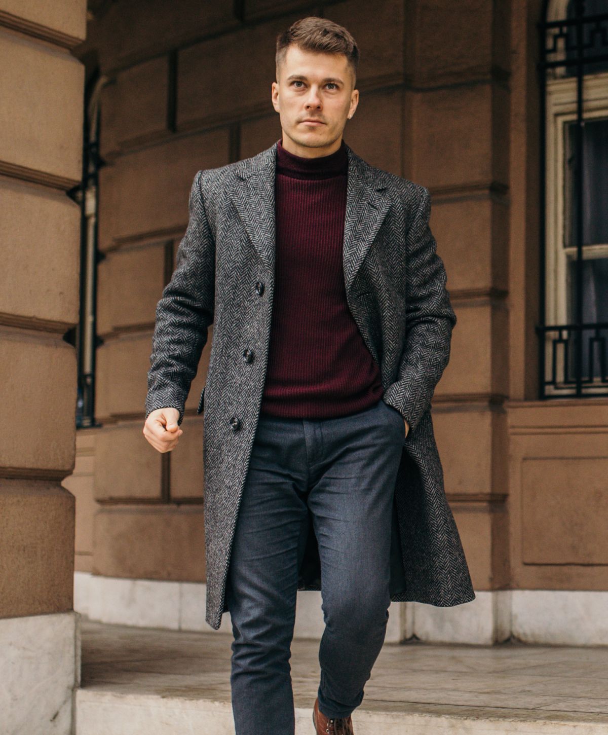 Man walking in stylish winter coat and sweater.