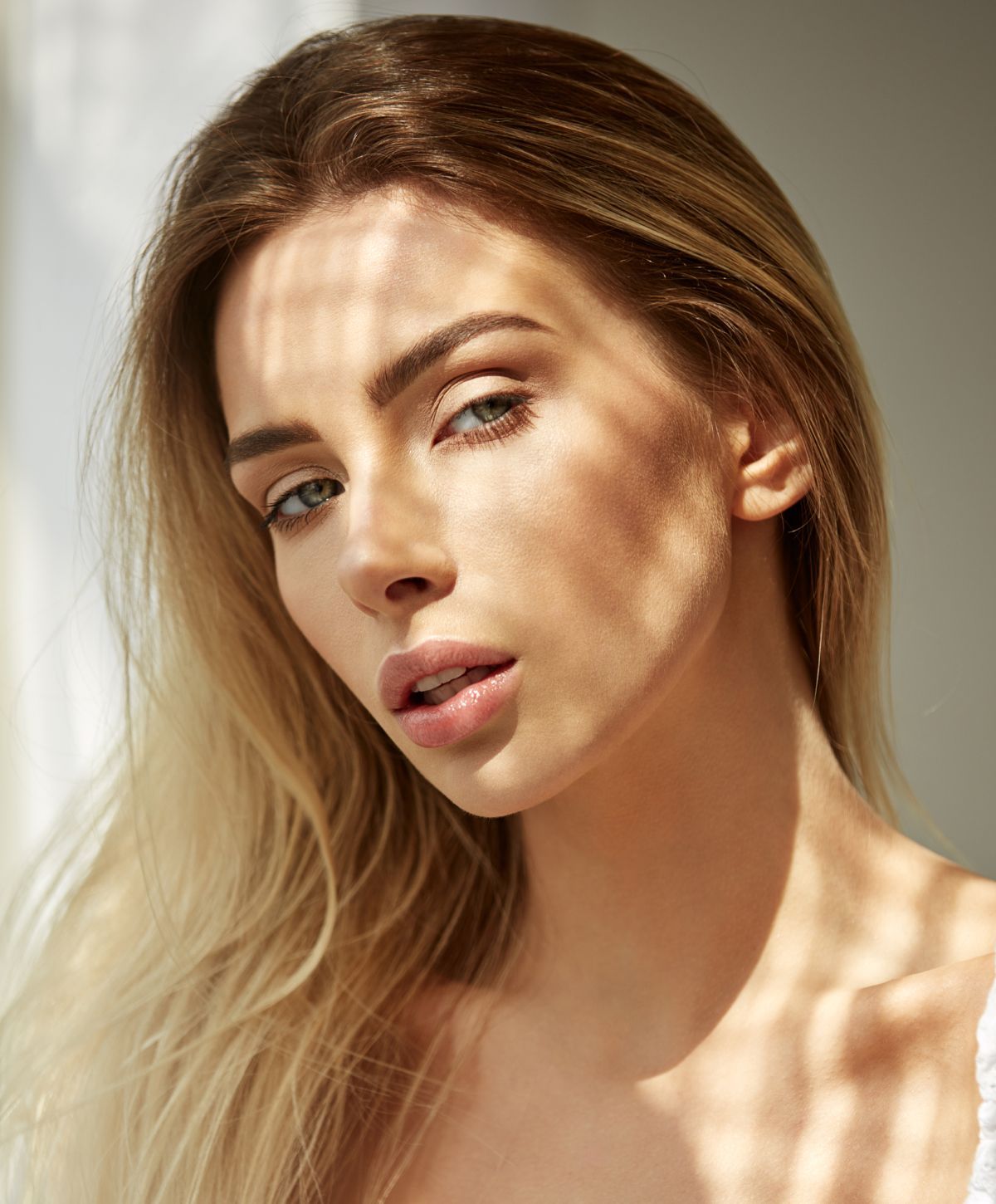 Woman's portrait with shadow patterns on her face.