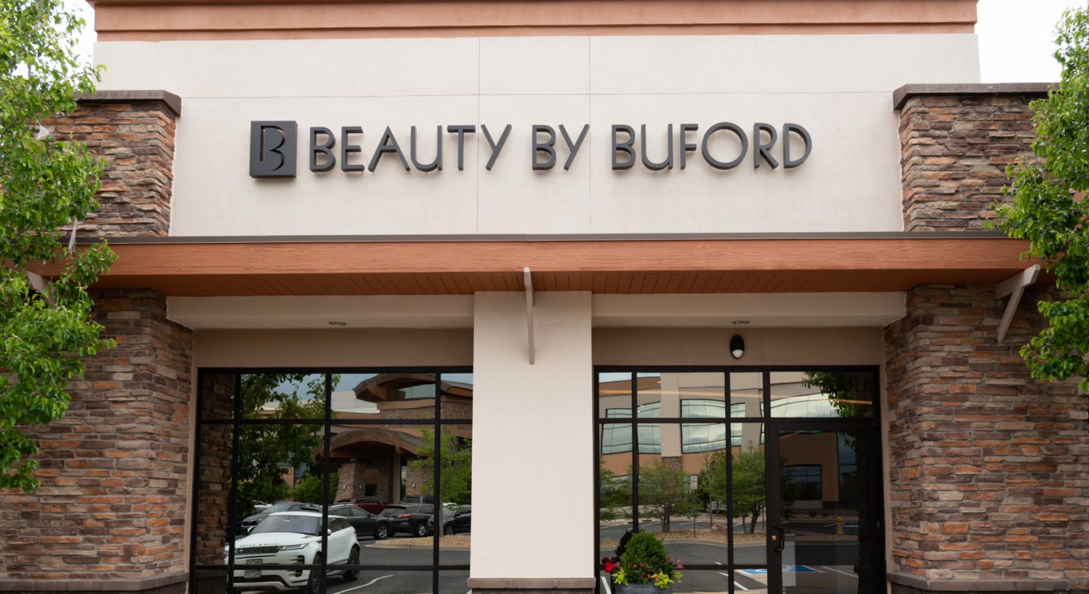 Beauty by Buford storefront sign outside building.