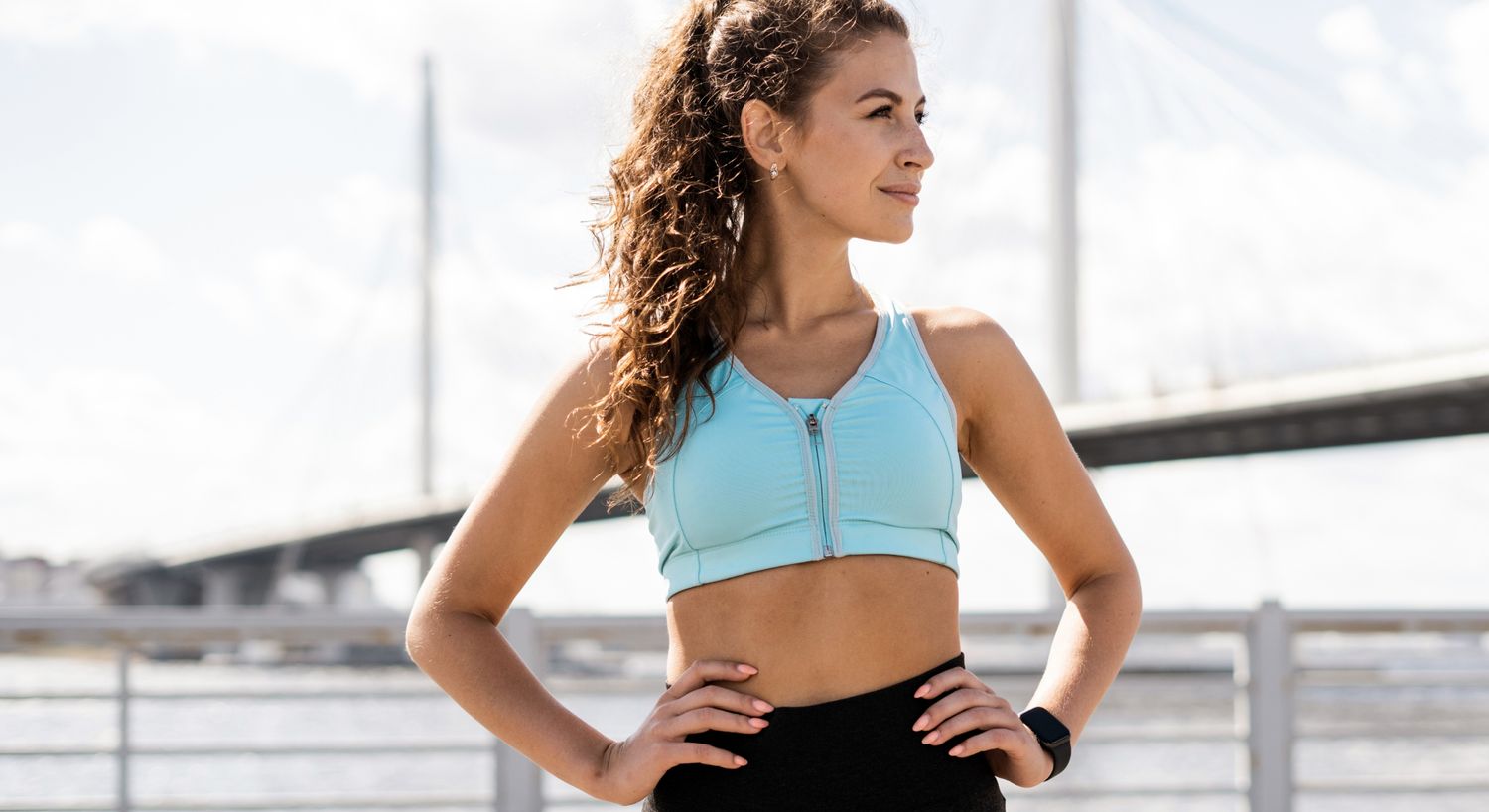 Denver Responsible Body Contouring model in activewear by waterfront bridge.