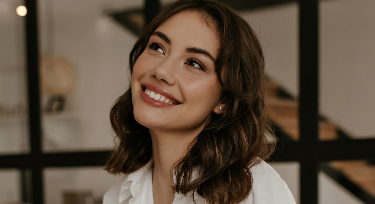 Smiling Denver Perlane model in a cozy indoor environment.